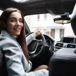 Post Breast Augmentation Driver looking in back seat checking on their recovery.