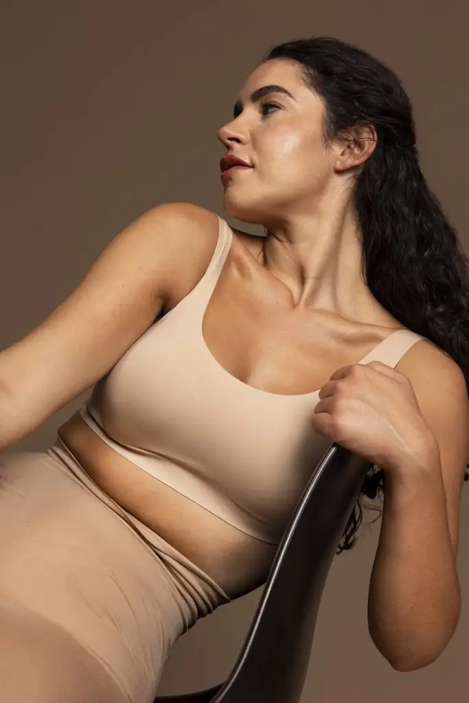 Woman considering breast lift procedure with capizzi md