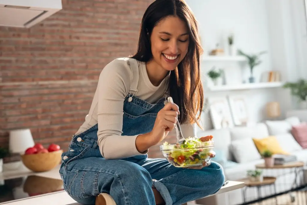 Happy woman enjoying a healthy meal after successful semaglutide weight loss treatment.